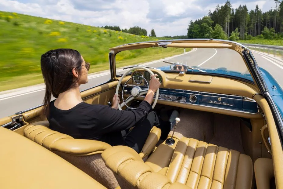Driver's view from inside a classic Mercedes 300 SL roadster on an open road