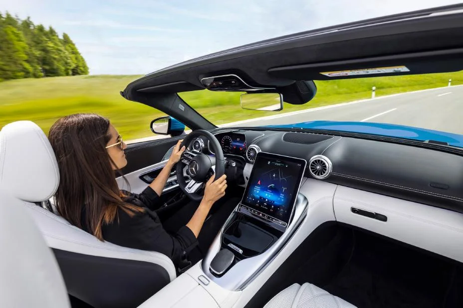 Driver's view from inside a top-down Mercedes-AMG SL roadster on an open country road