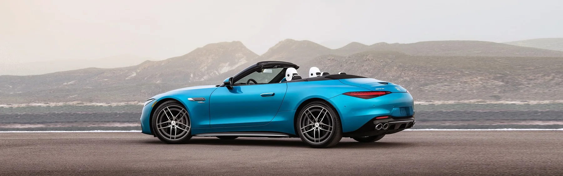 Blue Mercedes-AMG SL Roadster, top down on an open road — available at Mercedes-Benz of Fort Walton Beach, 1000 Beal Parkway NW, Florida