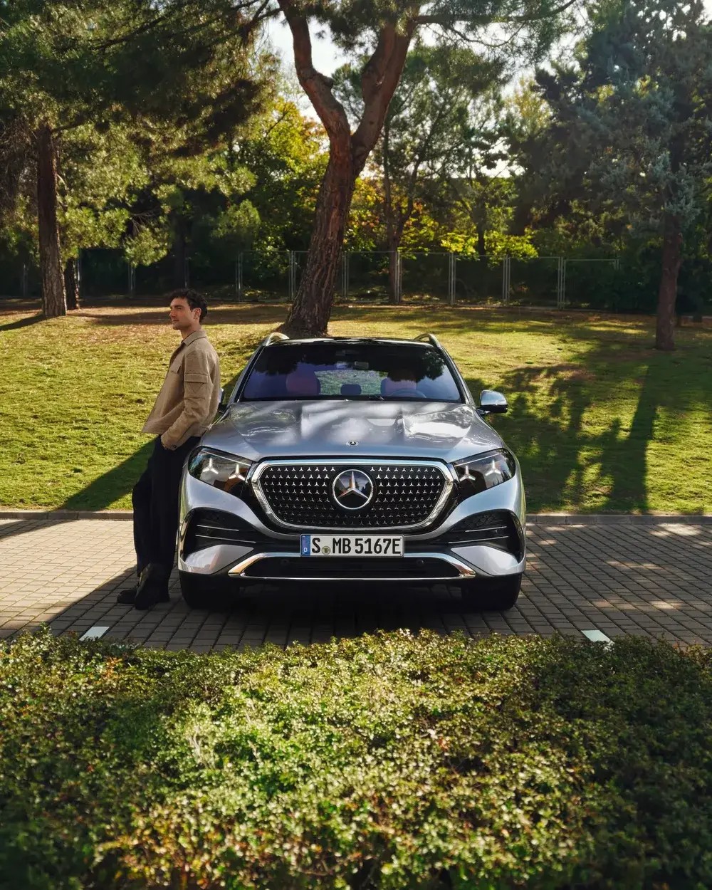 Mercedes-Benz GLE midsize SUV parked under the trees, the GLS's smaller sibling, available at Mercedes-Benz of Fort Walton Beach, FL