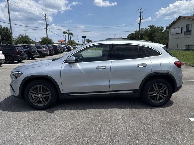 Certified pre-owned Mercedes-Benz GLA with the dealership inventory lined up behind it