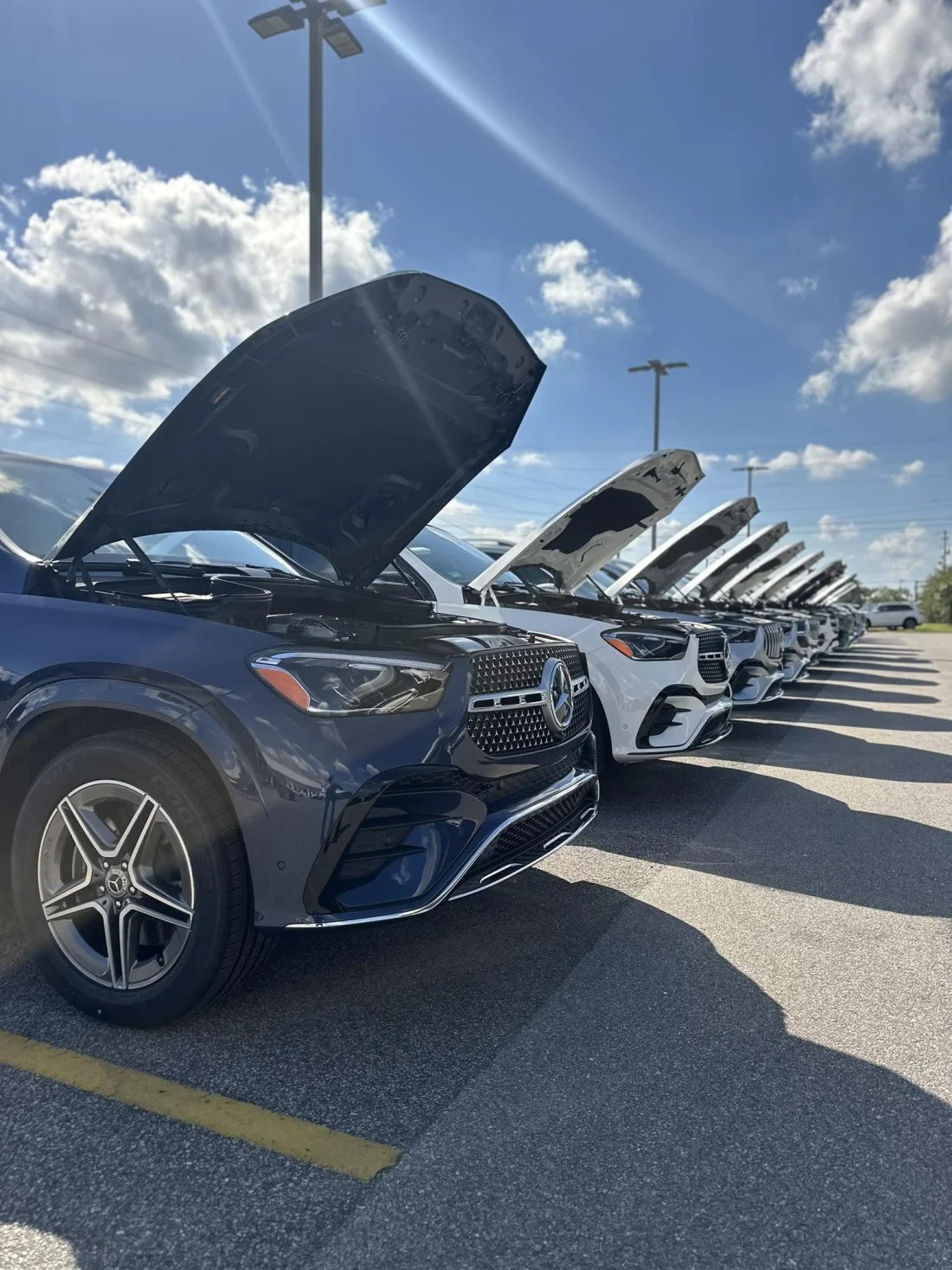 Row of Mercedes-Benz SUVs with hoods raised during inspection at Mercedes-Benz of Fort Walton Beach