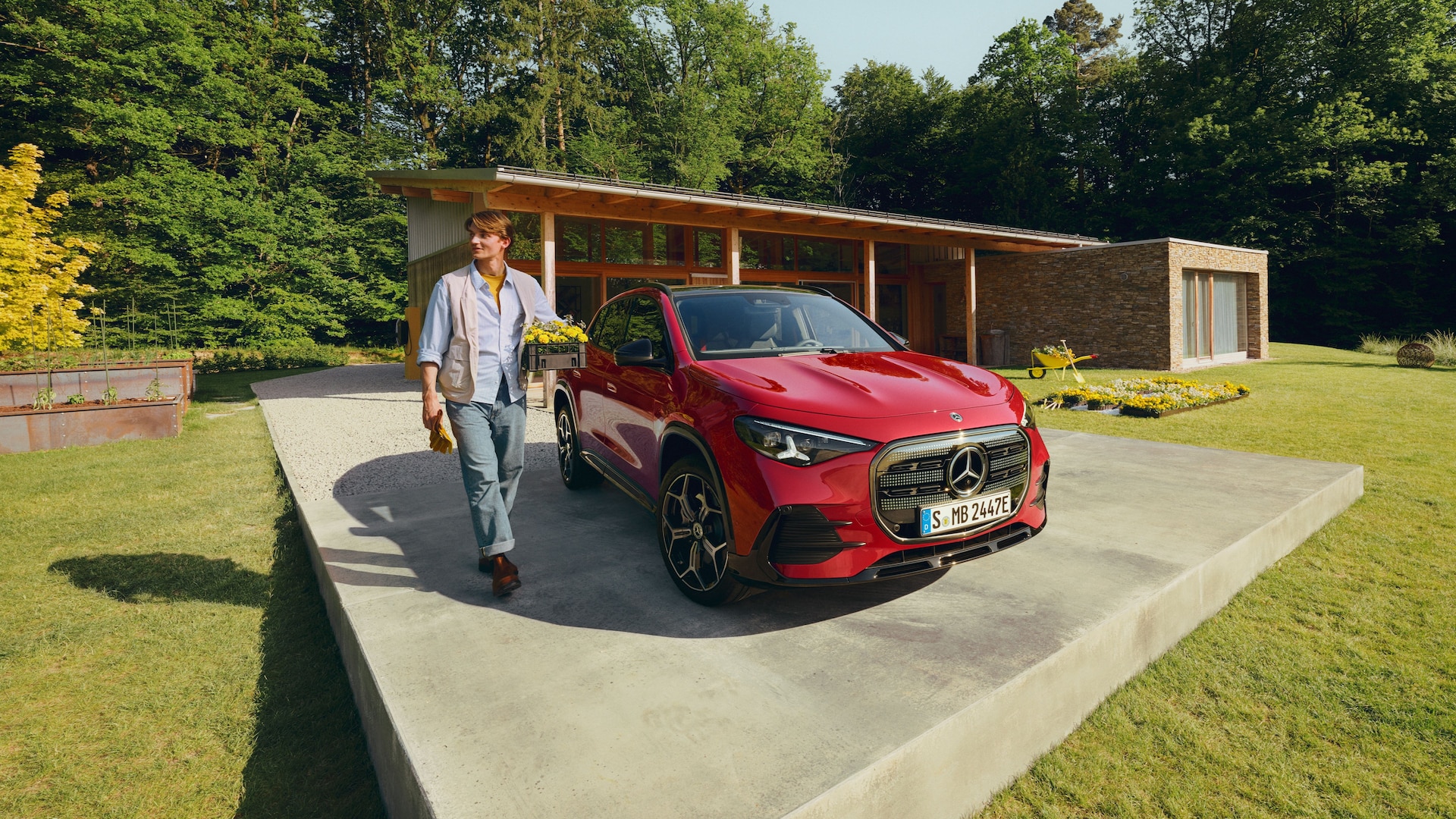 A Mercedes-Benz GLA SUV with its tailgate open, being loaded